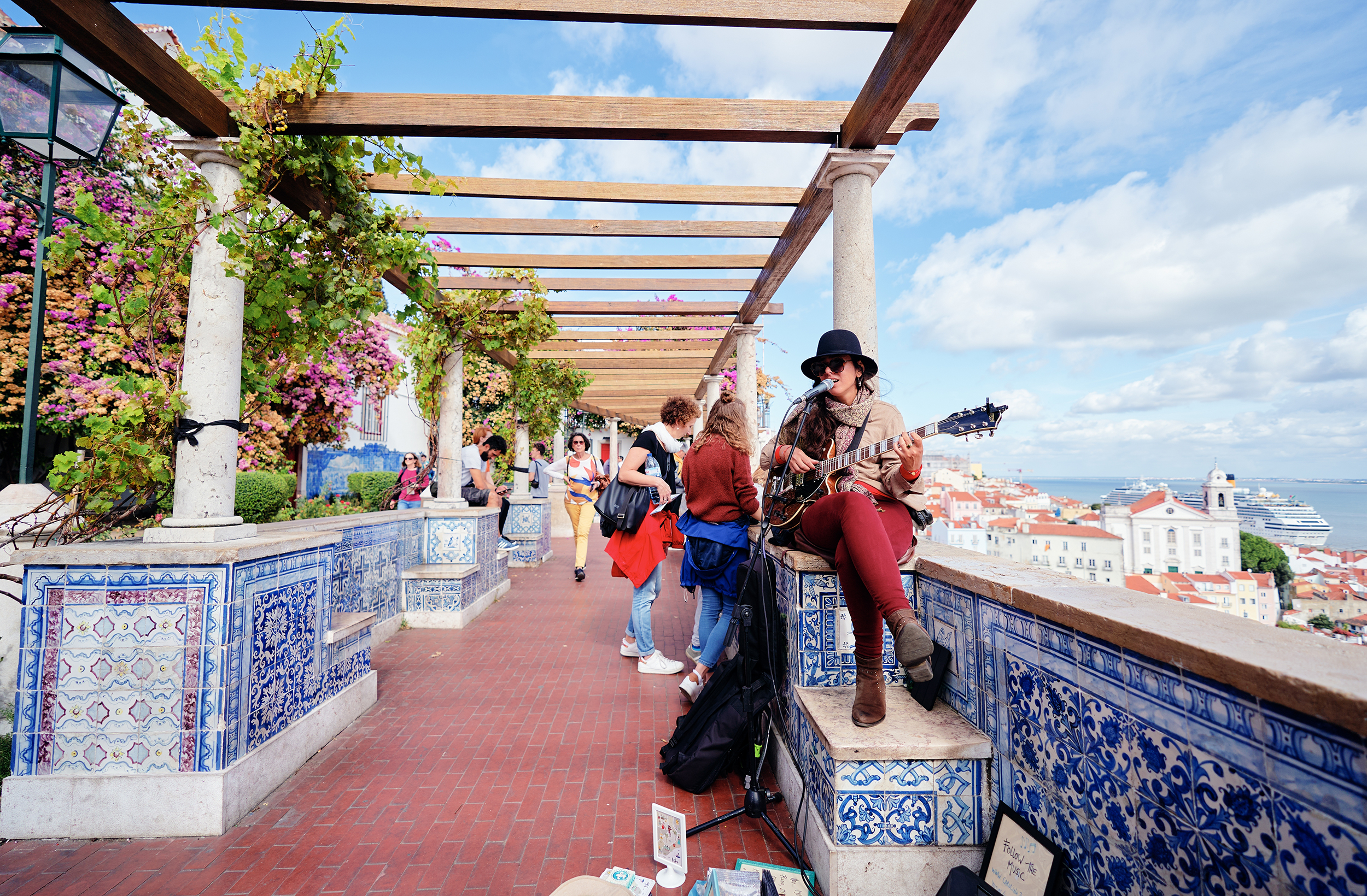 A,Street,Musician,Plays,Guitar,On,A,Scenic,Terrace,Overlooking